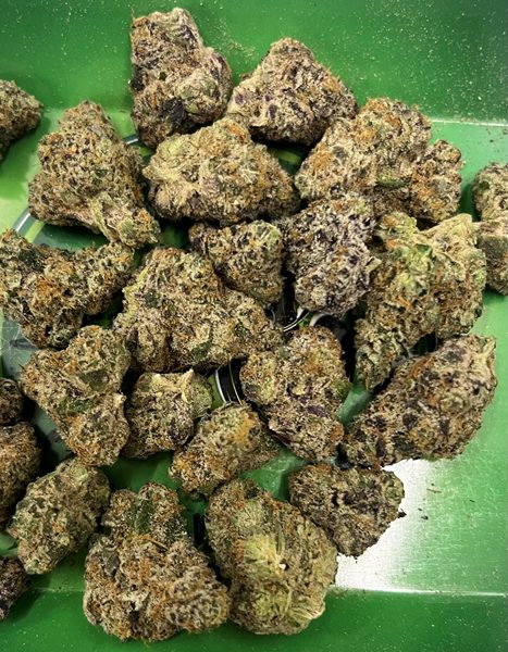 Loose flower buds from the TOKE It Up menu, photographed on the shop counter